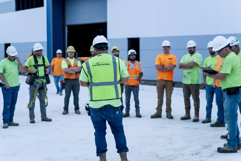 Operations team listening to superintendent during a toolbox talk.