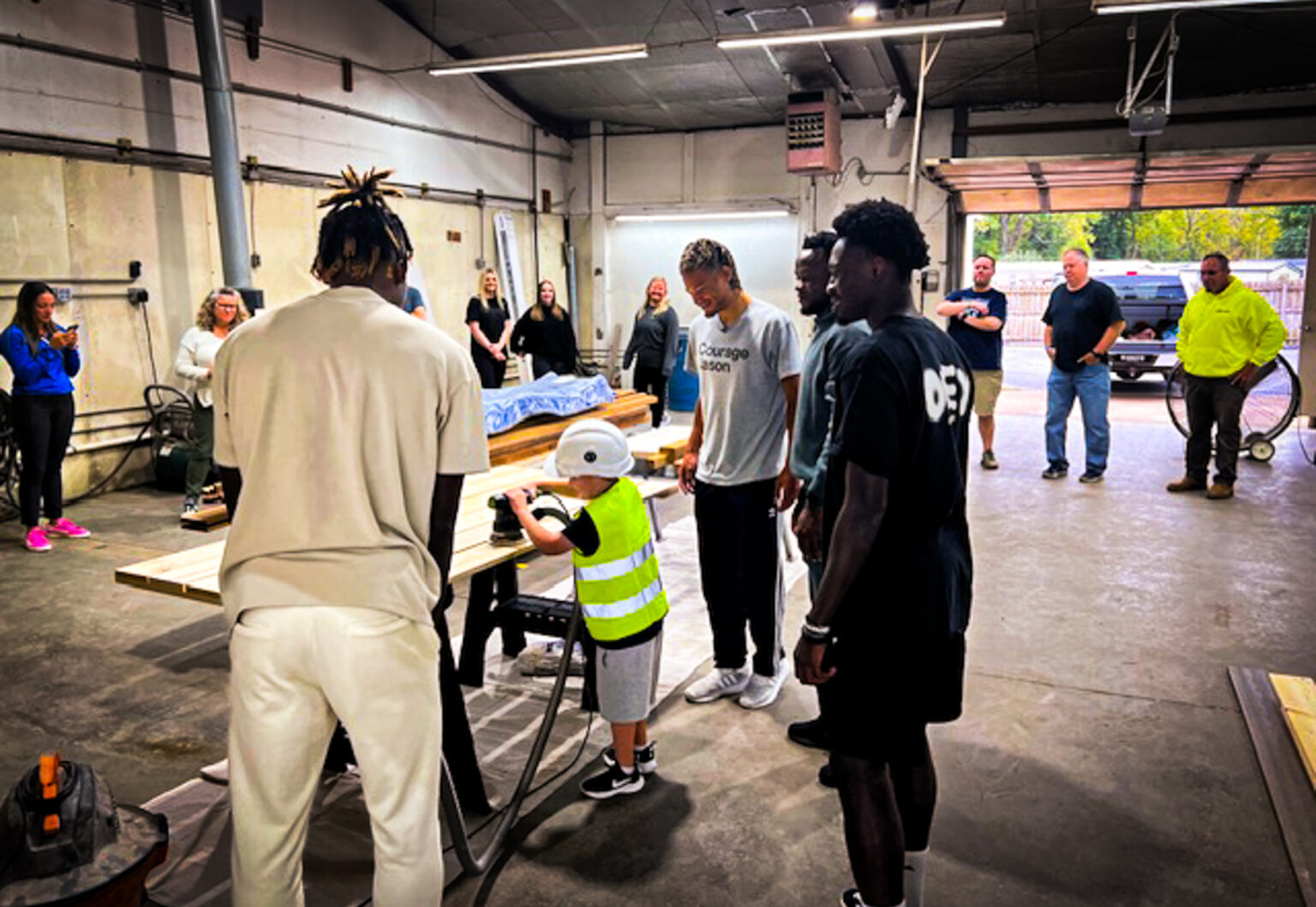 Sporting KC soccer players volunteering to build indoor playground