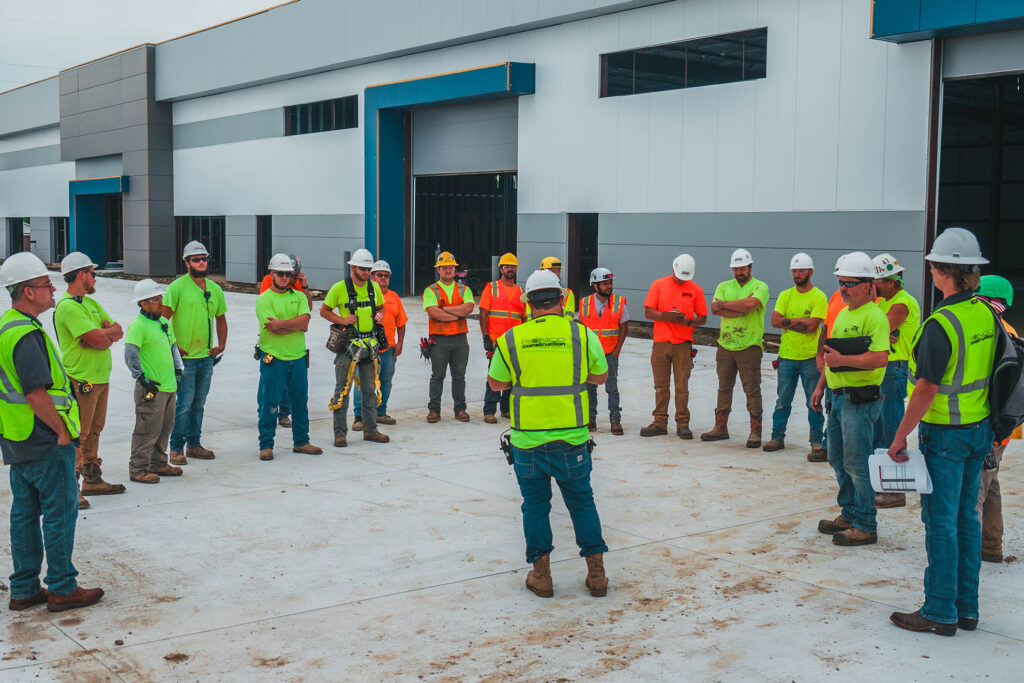 Construction team holding safety meeting on site.