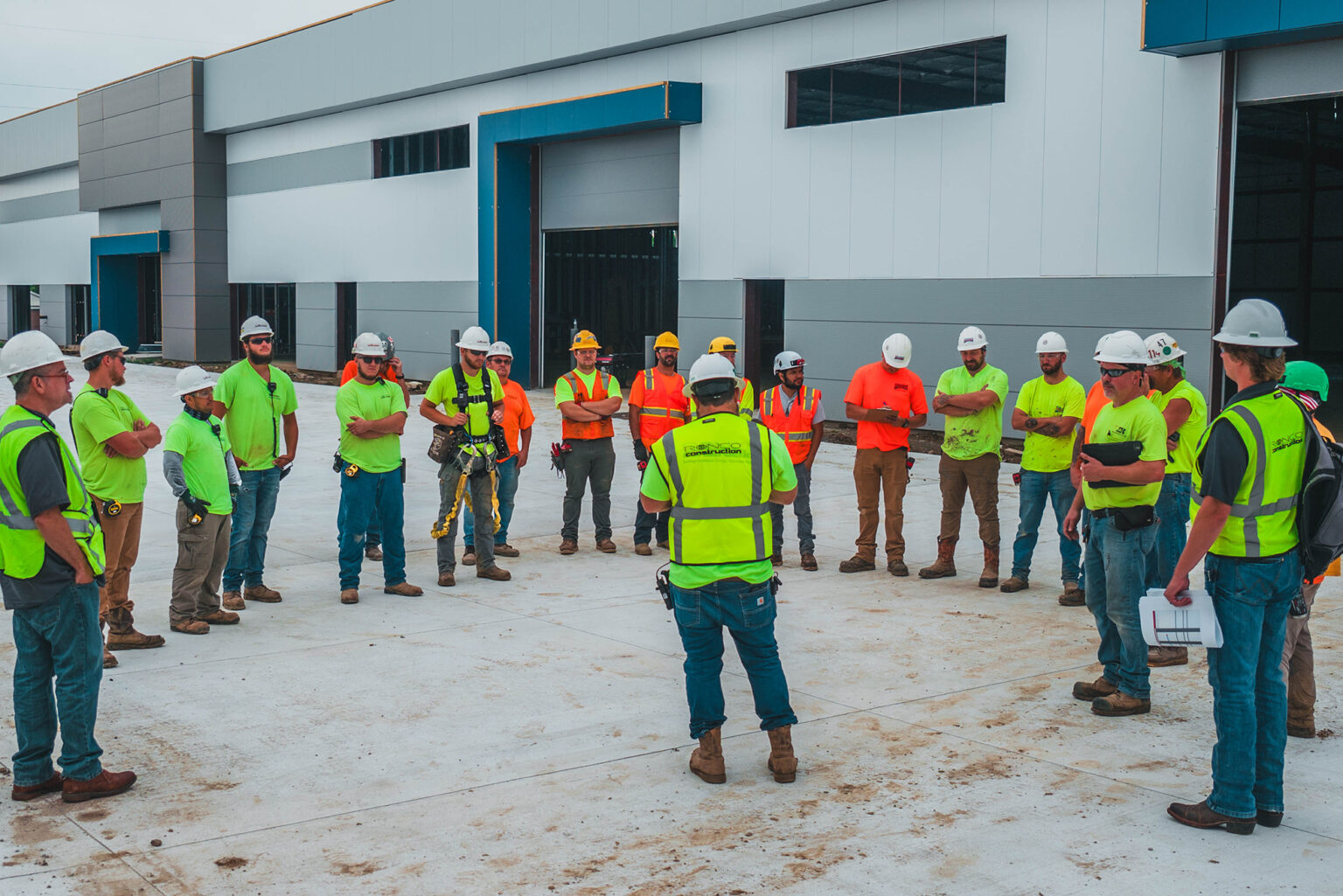 Construction team holding safety meeting on site.